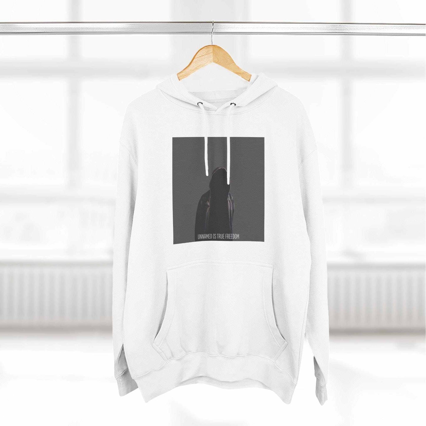 White hoodie with a graphic design on a hanger against a white background