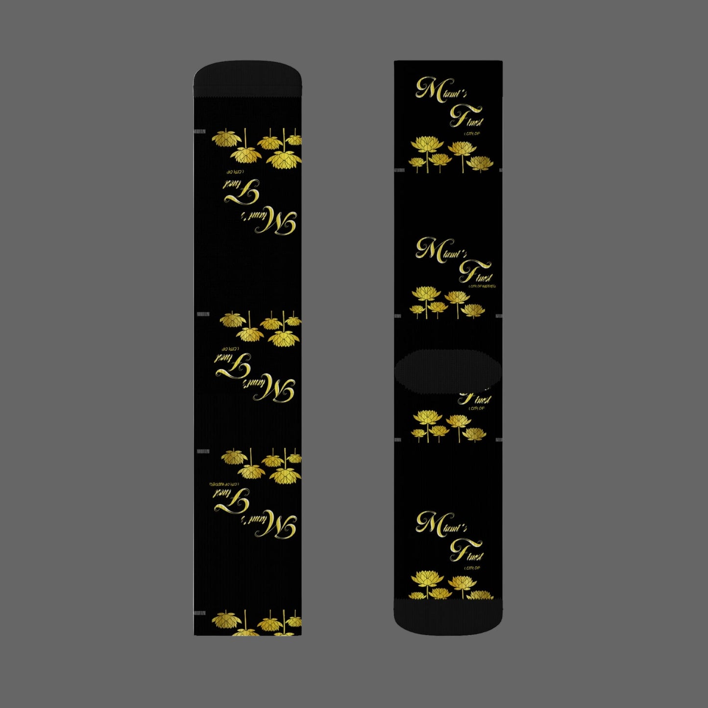 Two black cylindrical products with gold floral designs and text on a white background