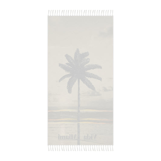 Beige towel with palm tree design and text on a white background