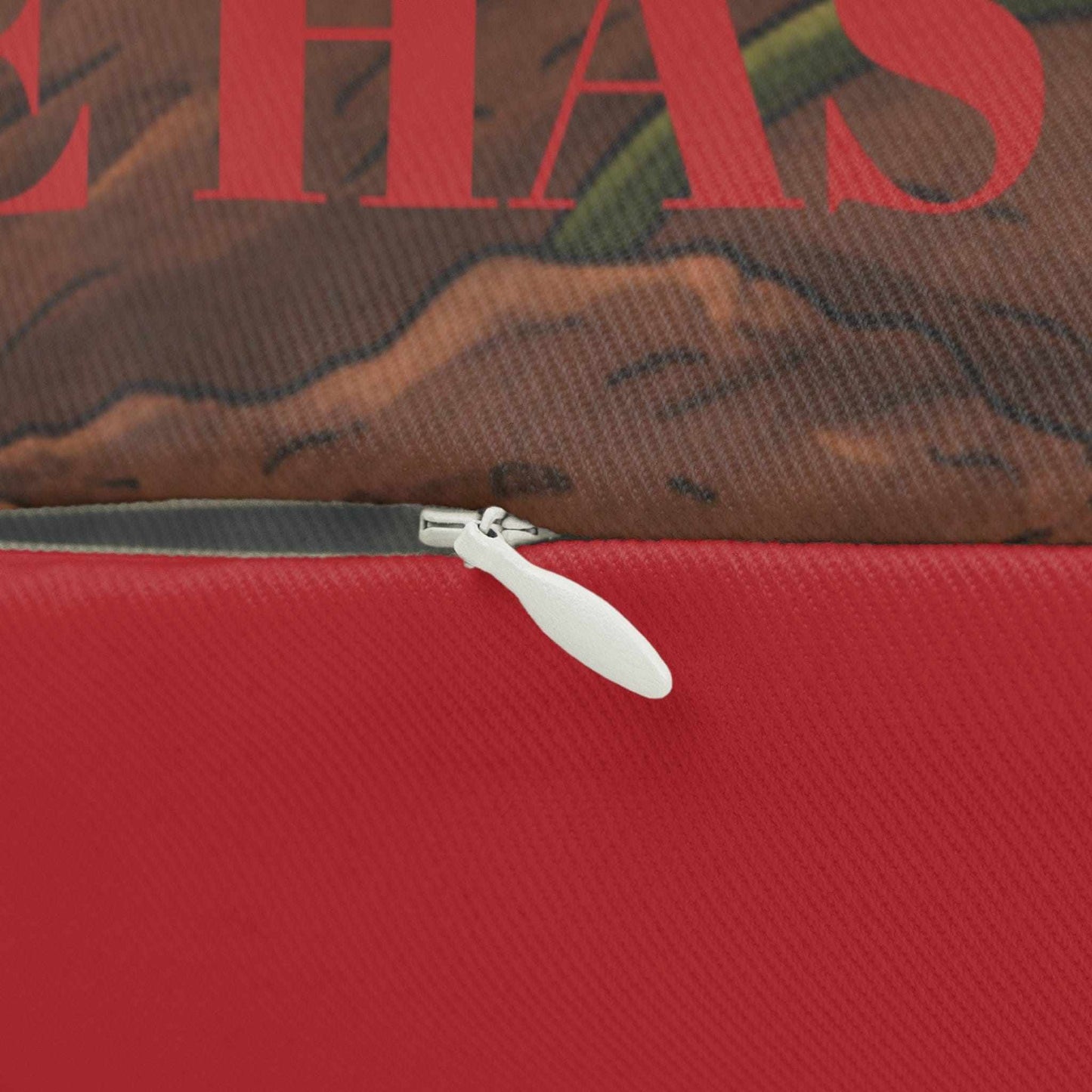 Lumbar Pillow — Romantic Rose Sunset Design Close-up of a red bag with a zipper, featuring text and a mountain graphic.