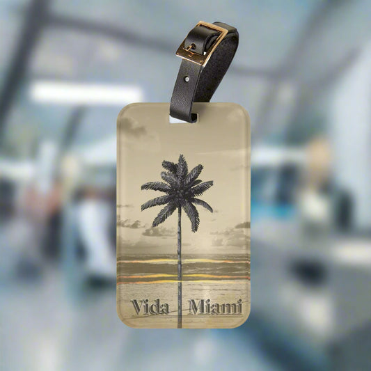 Luggage tag with palm tree design and 'Vida Miami' text on a white background