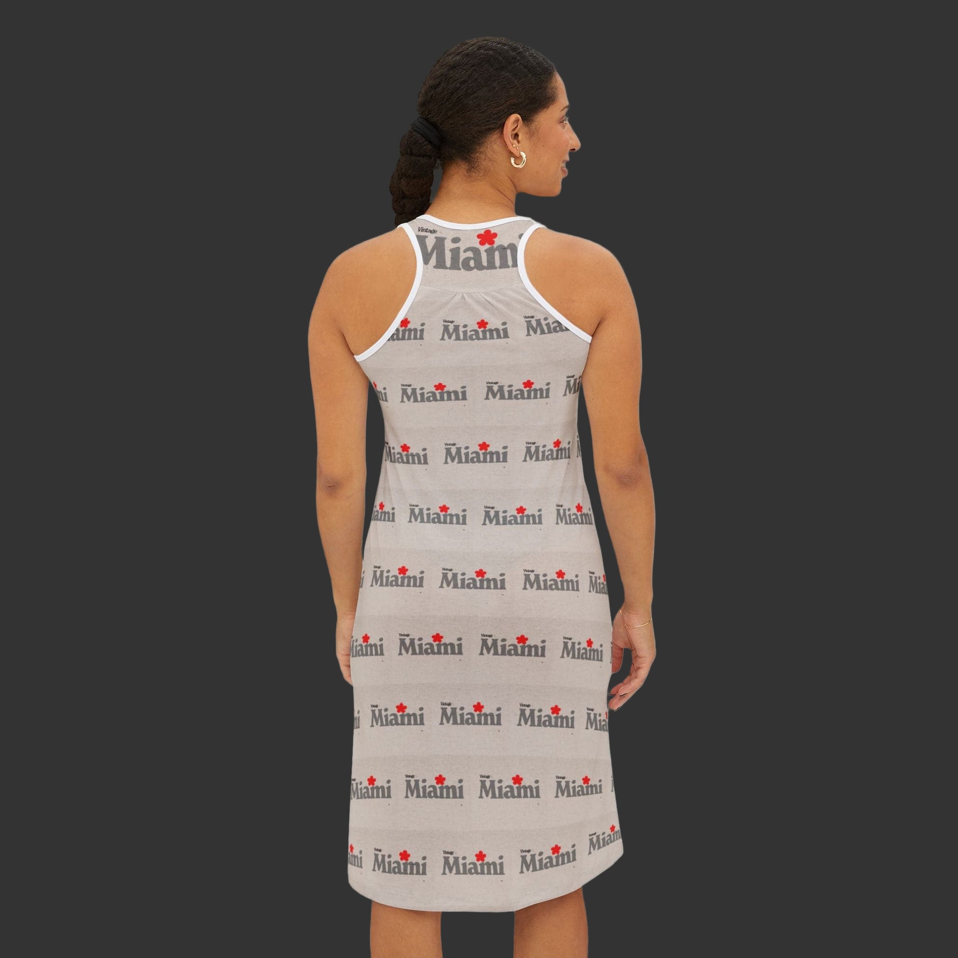 Woman wearing a sleeveless dress with 'Miami' print on a white background