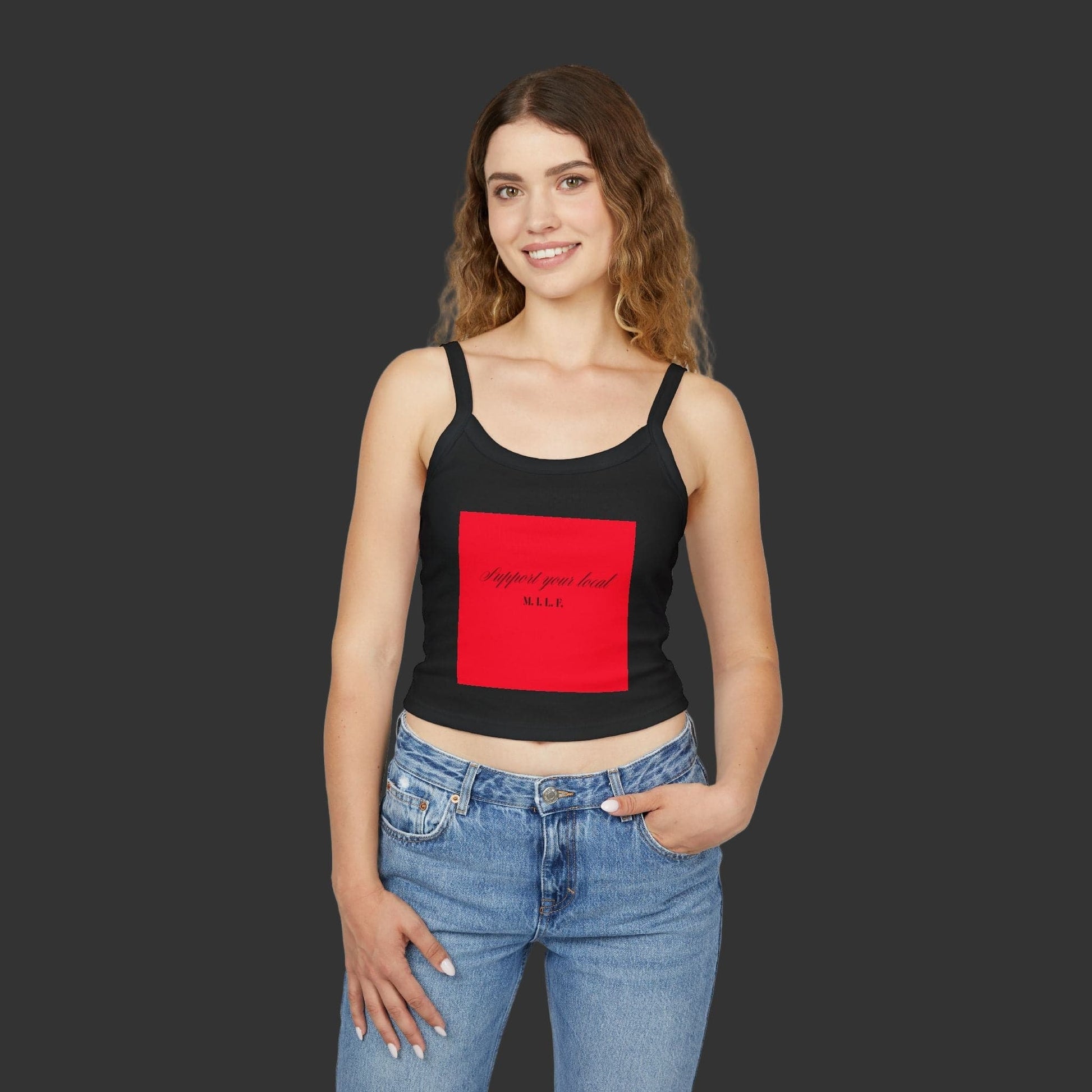 Woman wearing a black graphic tank top with a red square design on a white background