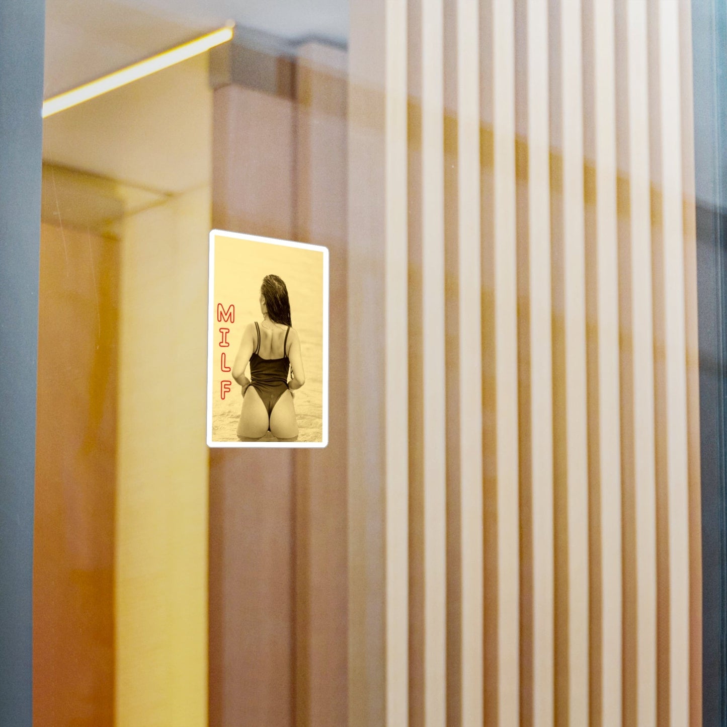 Digital display showing a person in a swimsuit with text on a wall.