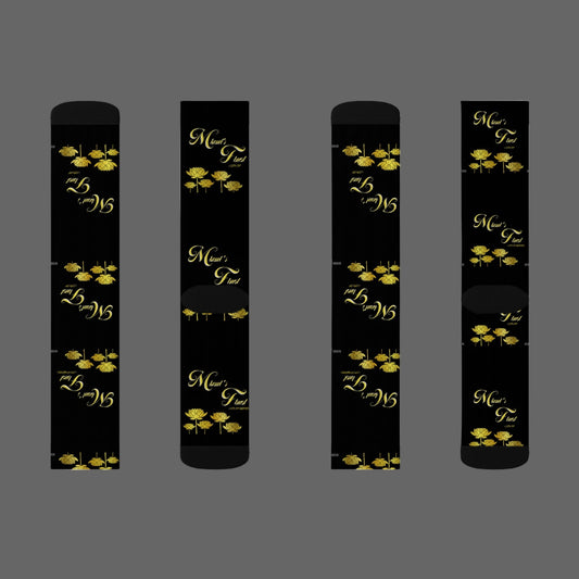 Four black cylindrical products with gold floral designs and text on a white background