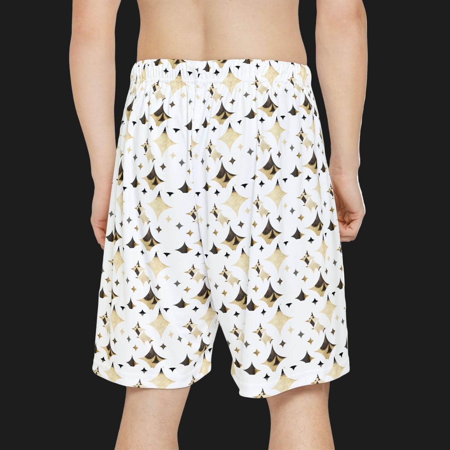 White shorts with black and gold geometric pattern worn by a person on a white background