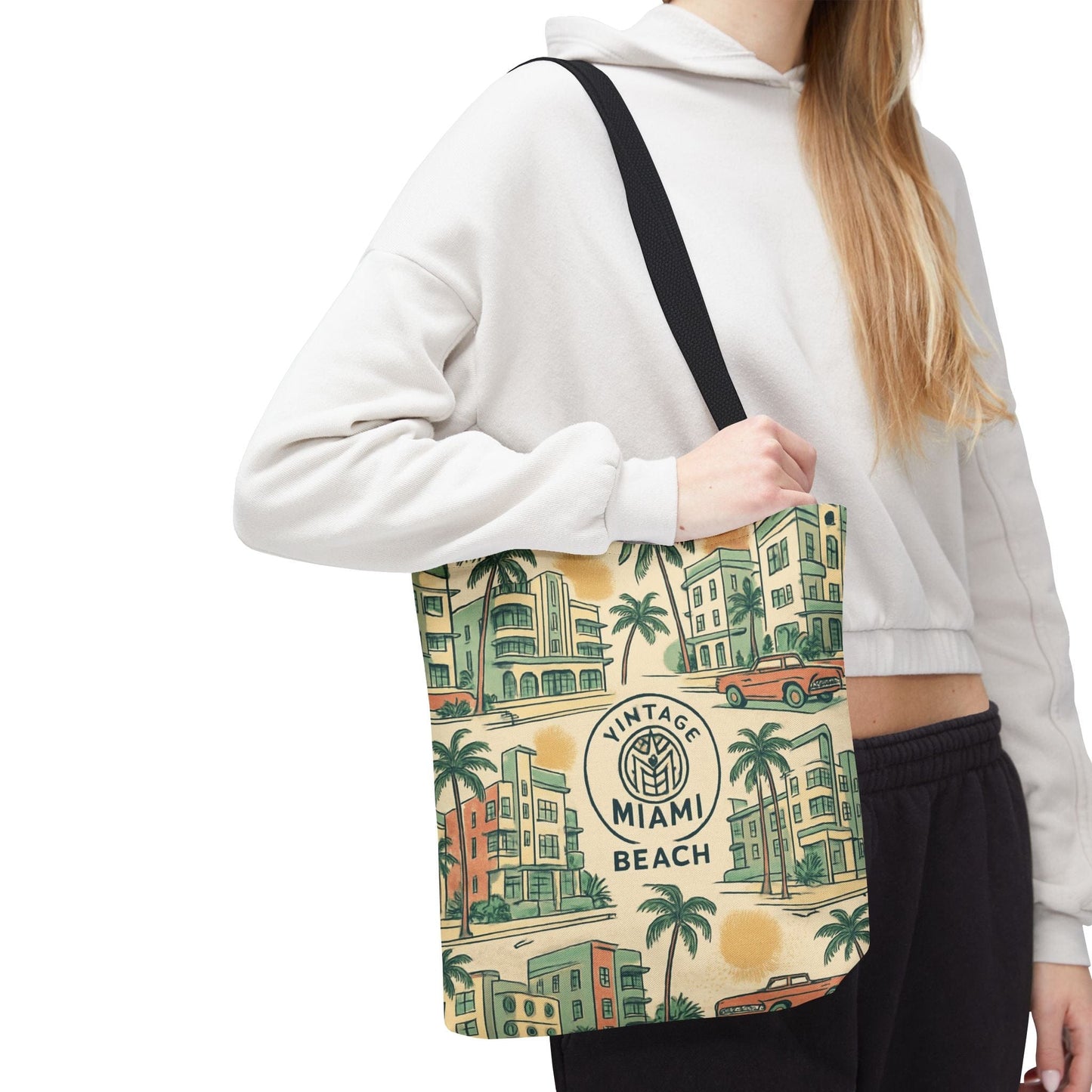 Person holding a tote bag with 'Vintage Miami Beach' design