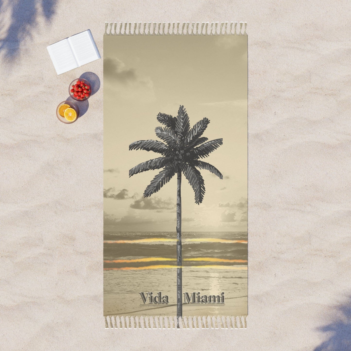 Beach towel with palm tree design and 'Vida Miami' text on a textured surface.
