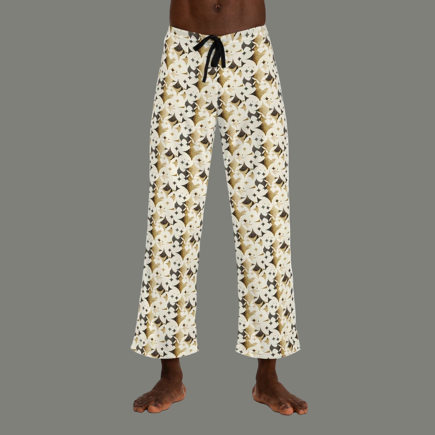 Monogram patterned pants worn by a person on a white background