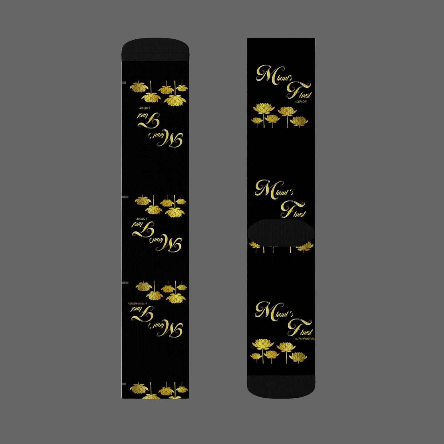 Two black sticks with gold floral designs and text on a white background