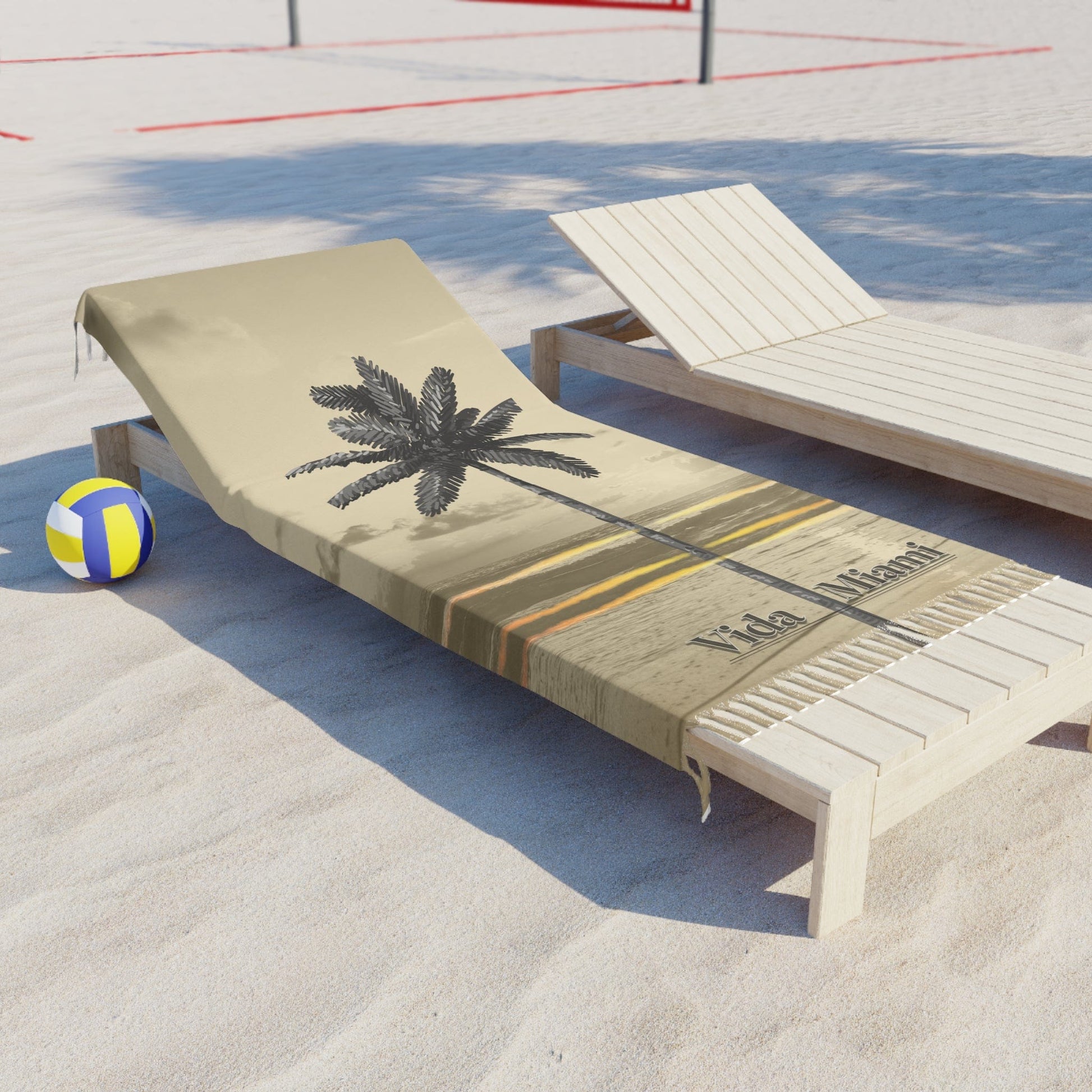 Beach chair with palm tree design on a sandy surface